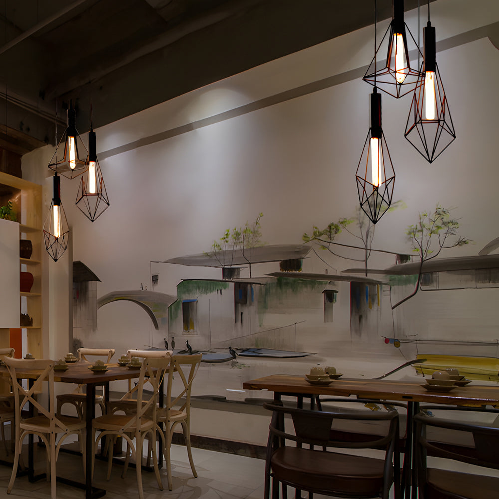 Black wire cage pendant light providing warm light in a cozy kitchen nook.