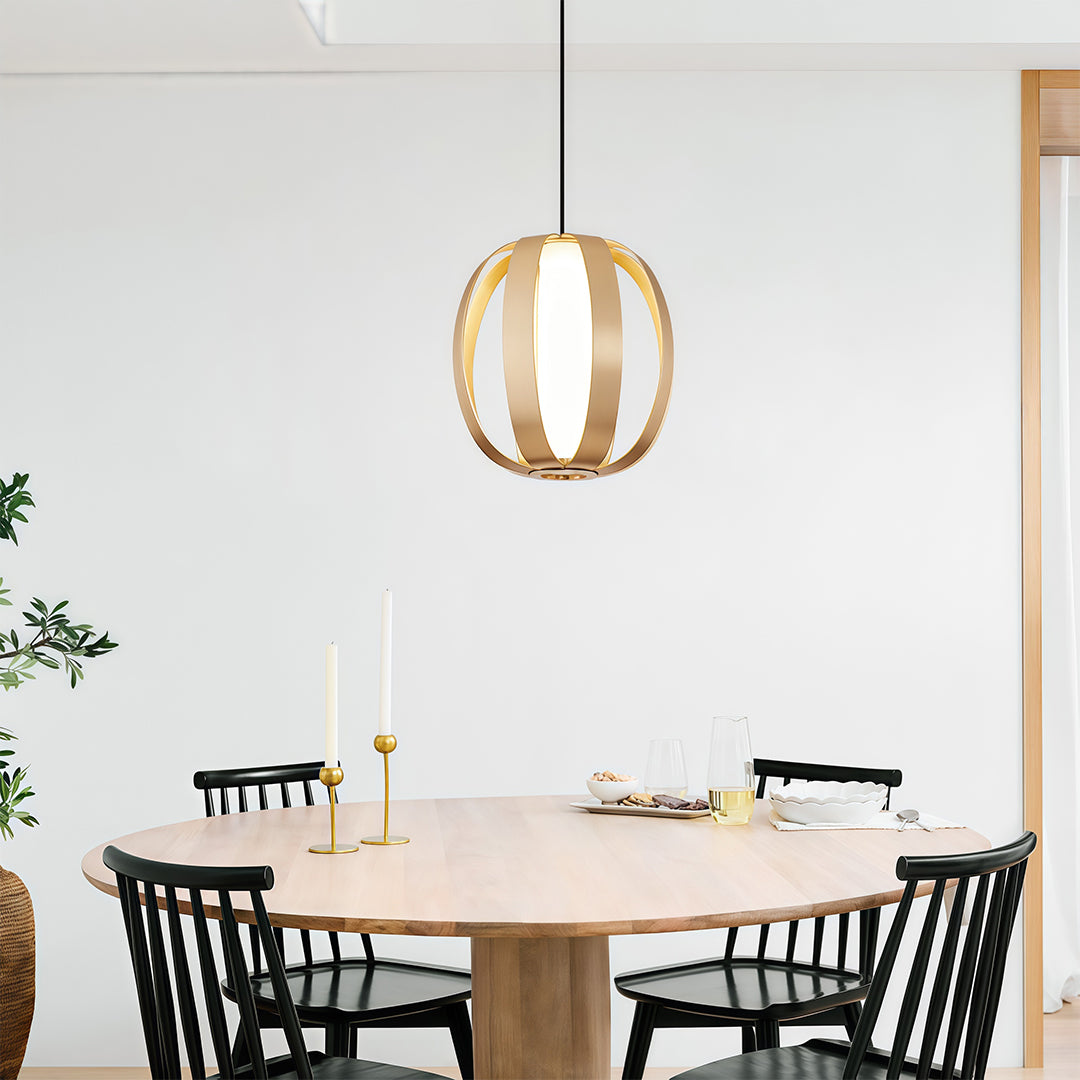Blonde wood lantern pendant light illuminating modern dining space with black windsor chairs.