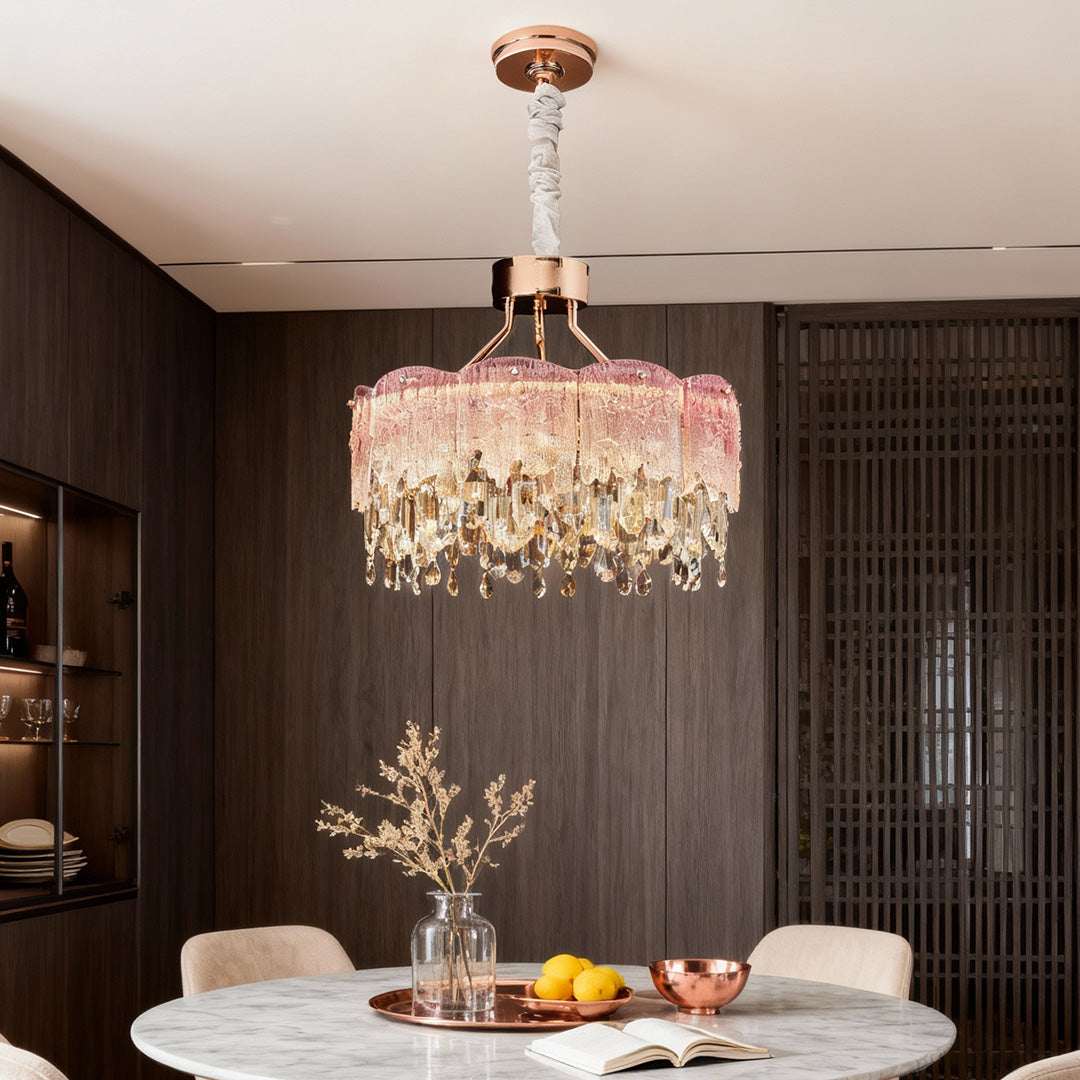 Dining space illuminated by blue glass fringe chandeliers with soft ambient lighting.