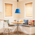 blue hanging pendant lights illuminating a cozy kitchen nook with natural wood blinds