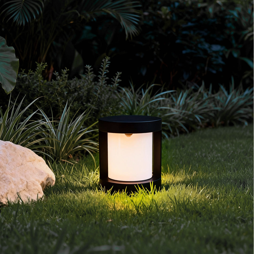 Bollard landscape light with a cylindrical shape, providing bright illumination in a garden setting.