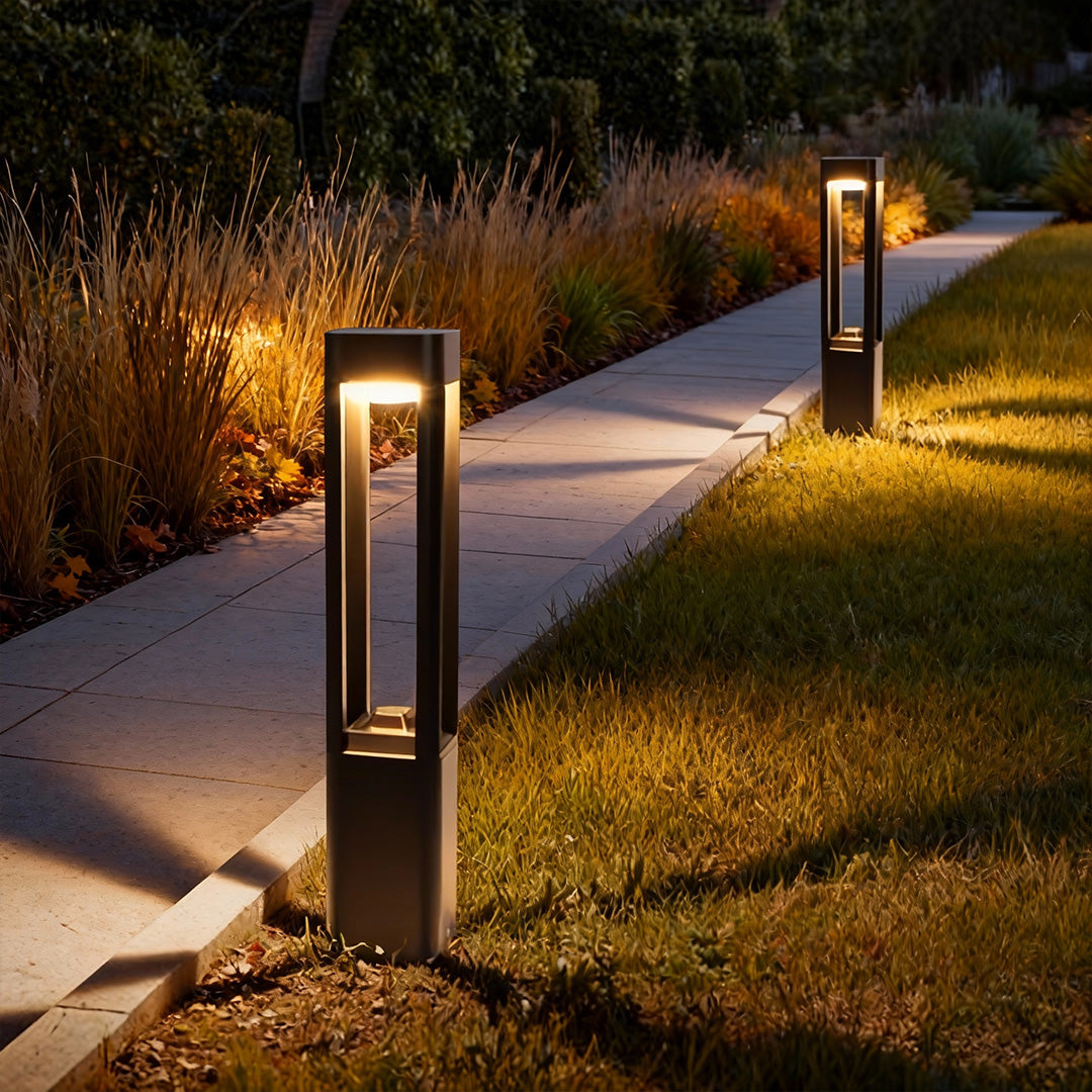 Bollard landscape lights guiding a curved outdoor walkway at night
