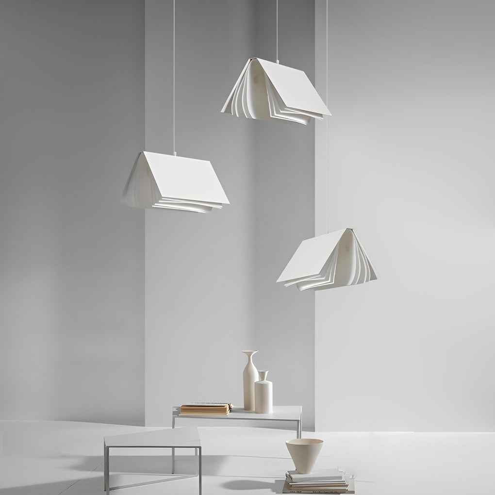 Sculptural book pendant light cluster in a modern living room, emphasizing layered pages and ambient glow.