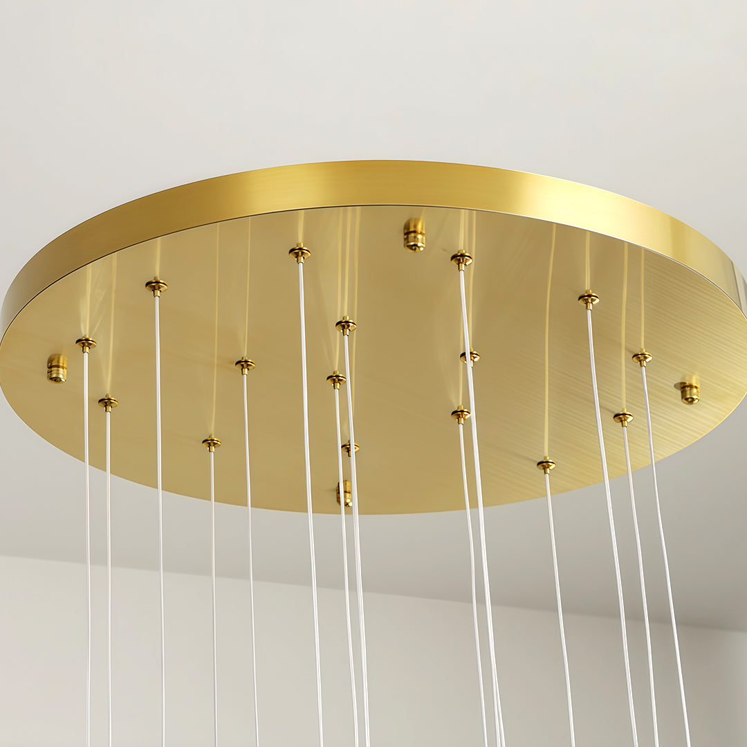 Ceiling mount plate of a modern brass ceramic chandeliers with multiple hanging lights.