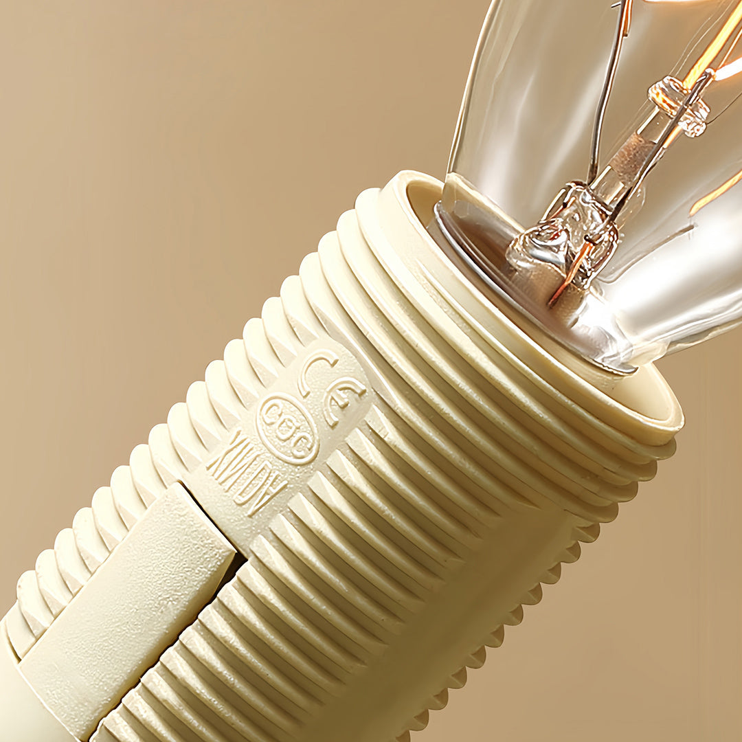 Macro detail of brass semi flush mount ceiling light highlighting pleated crystal shade and chain suspension