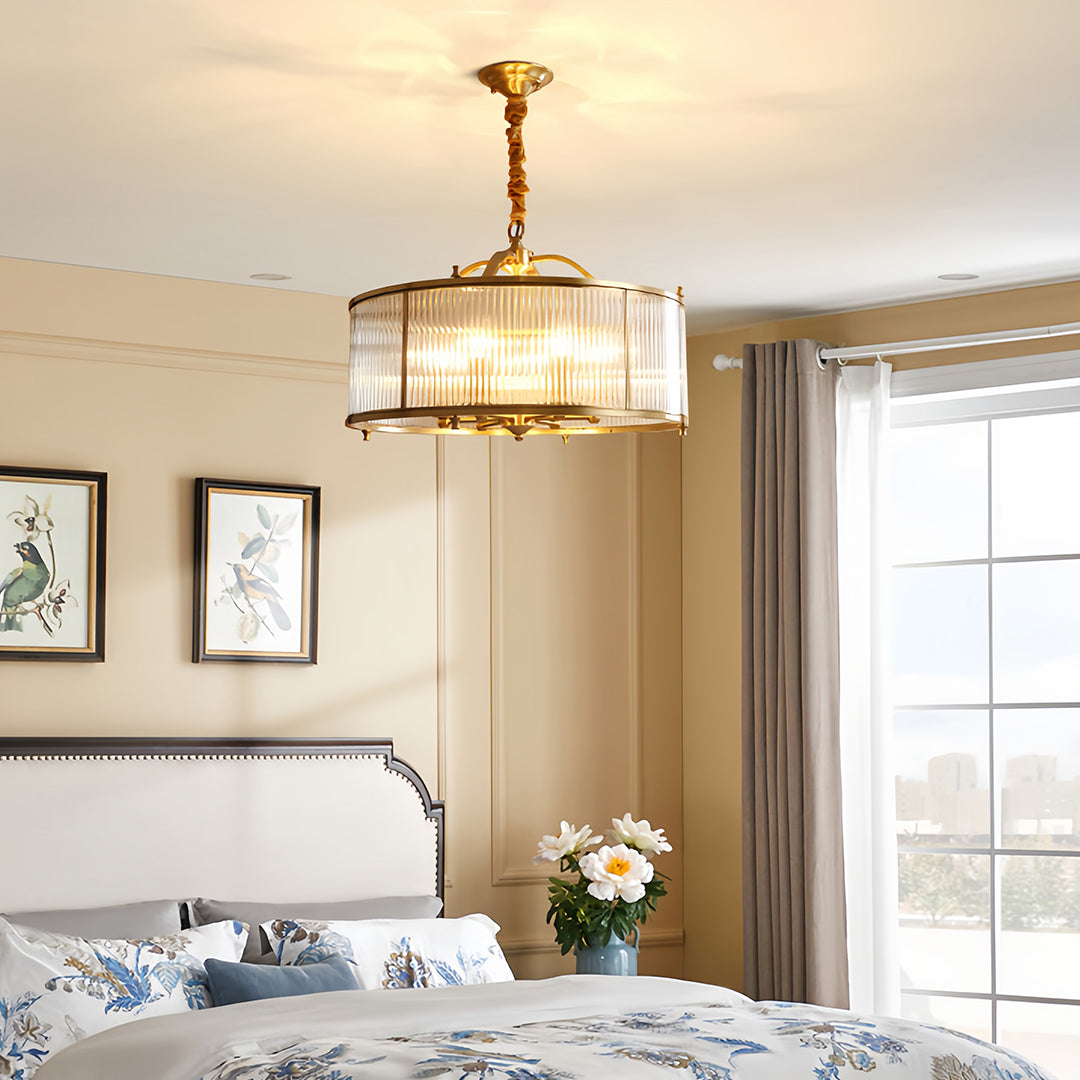 Brass semi flush mount ceiling light installed in master bedroom with upholstered headboard and artwork