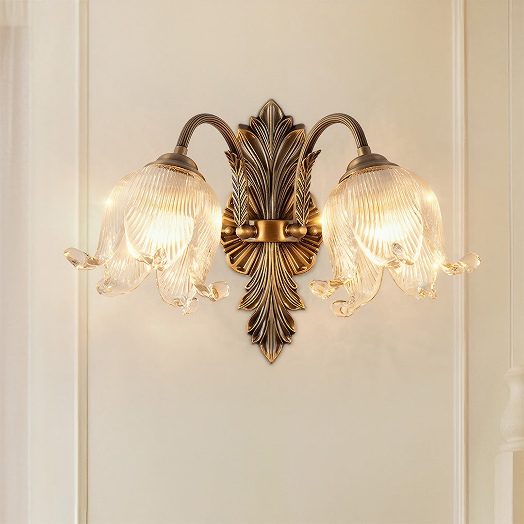 Brass wall lights installed in elegant room with white paneling and traditional furnishings