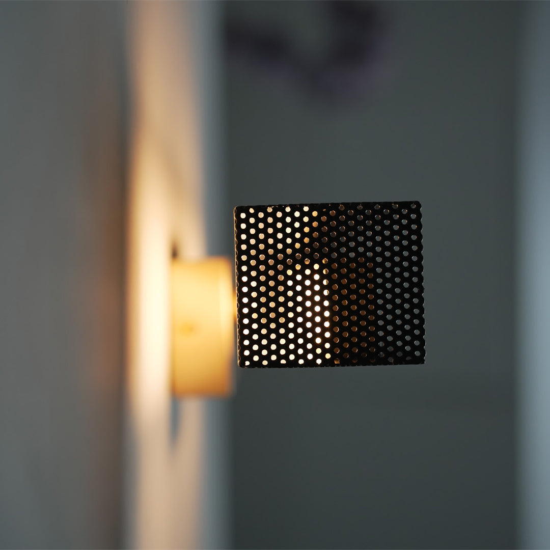 Brass wall picture lights mounted on white wall, showcasing minimalist geometric style.