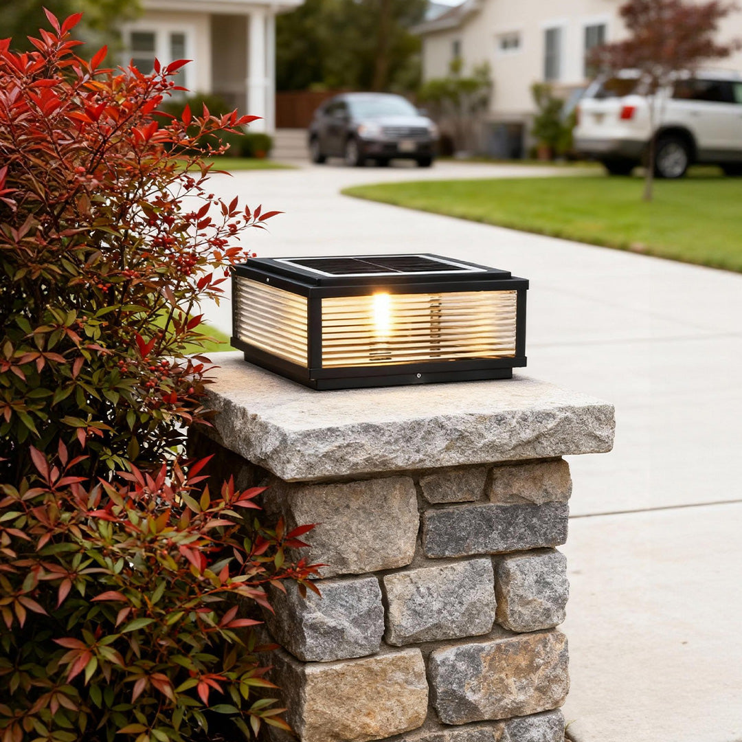 Square pillar light mounted on brick pillar, offering warm and inviting light for driveway entrance.