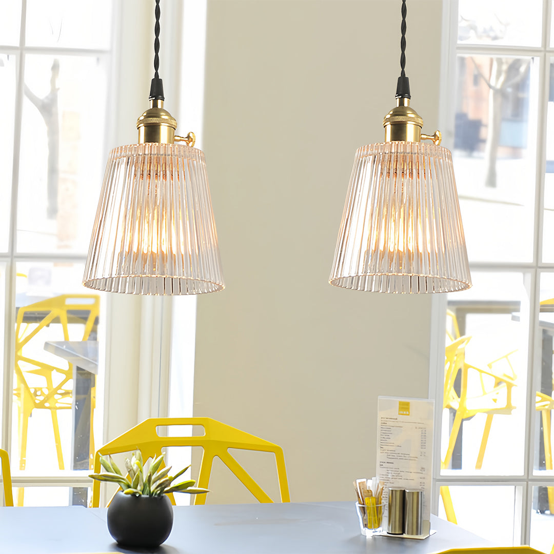 Bright kitchen space with clear glass pendant lights offering clean contemporary lighting design