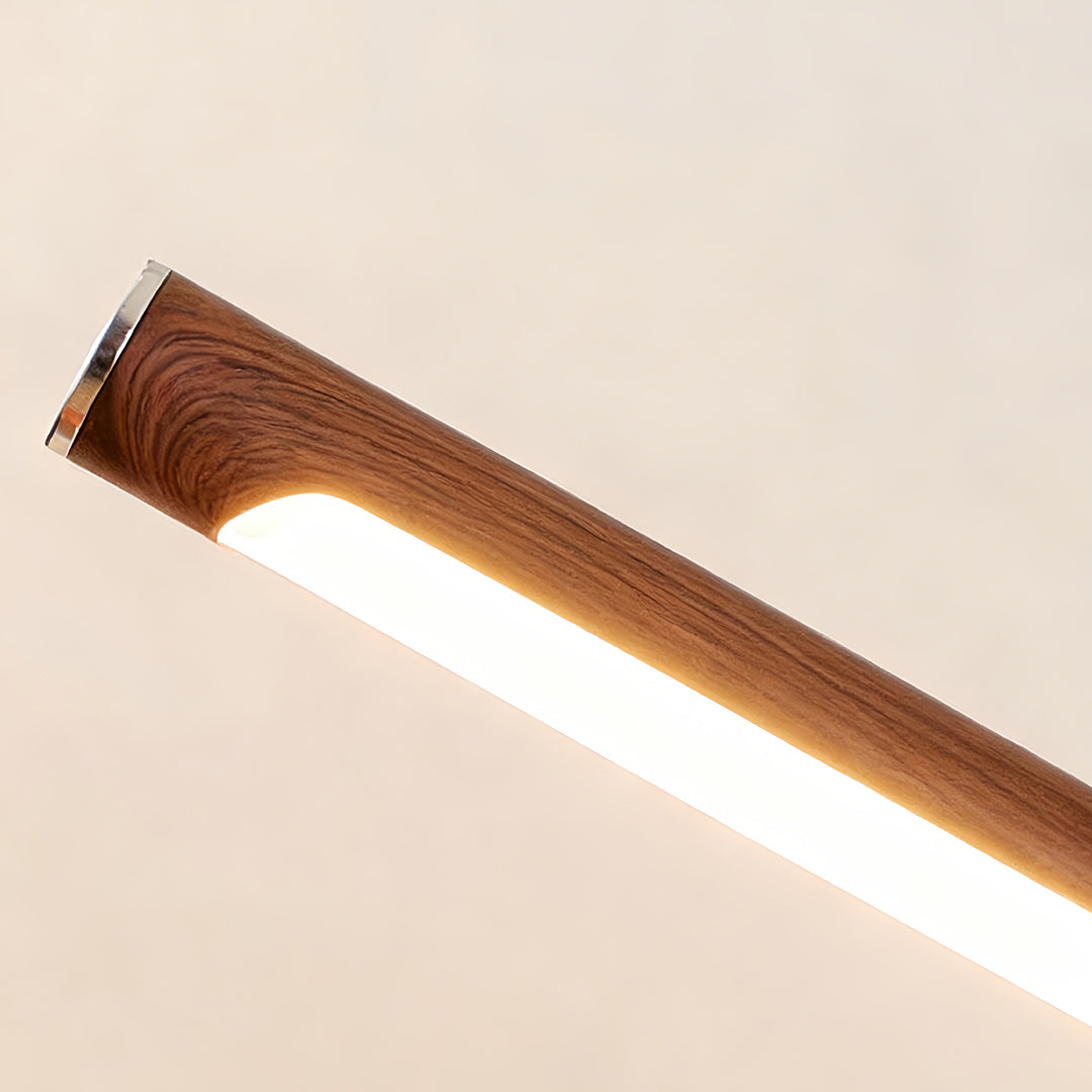 Bright LED strip lighting detail of the swing wall light showing warm illumination and smooth wood finish.