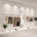 Bright recessed LED ceiling downlights illuminating a modern retail clothing boutique interior.