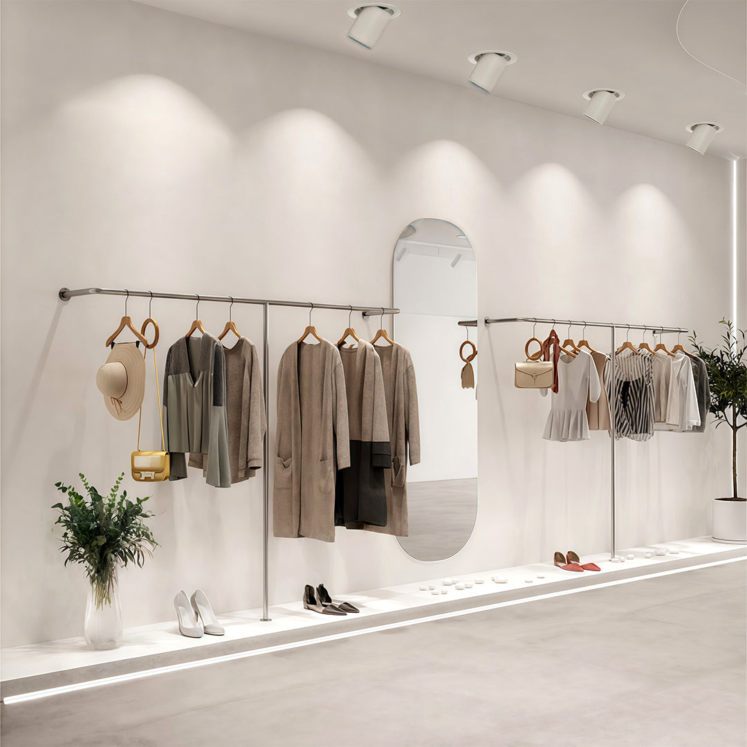 Bright recessed LED ceiling downlights illuminating a modern retail clothing boutique interior.