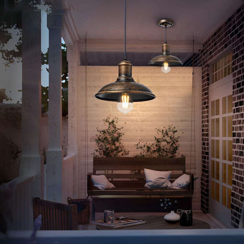 Bronze pendant lighting providing soft illumination for a cozy outdoor lounge area.