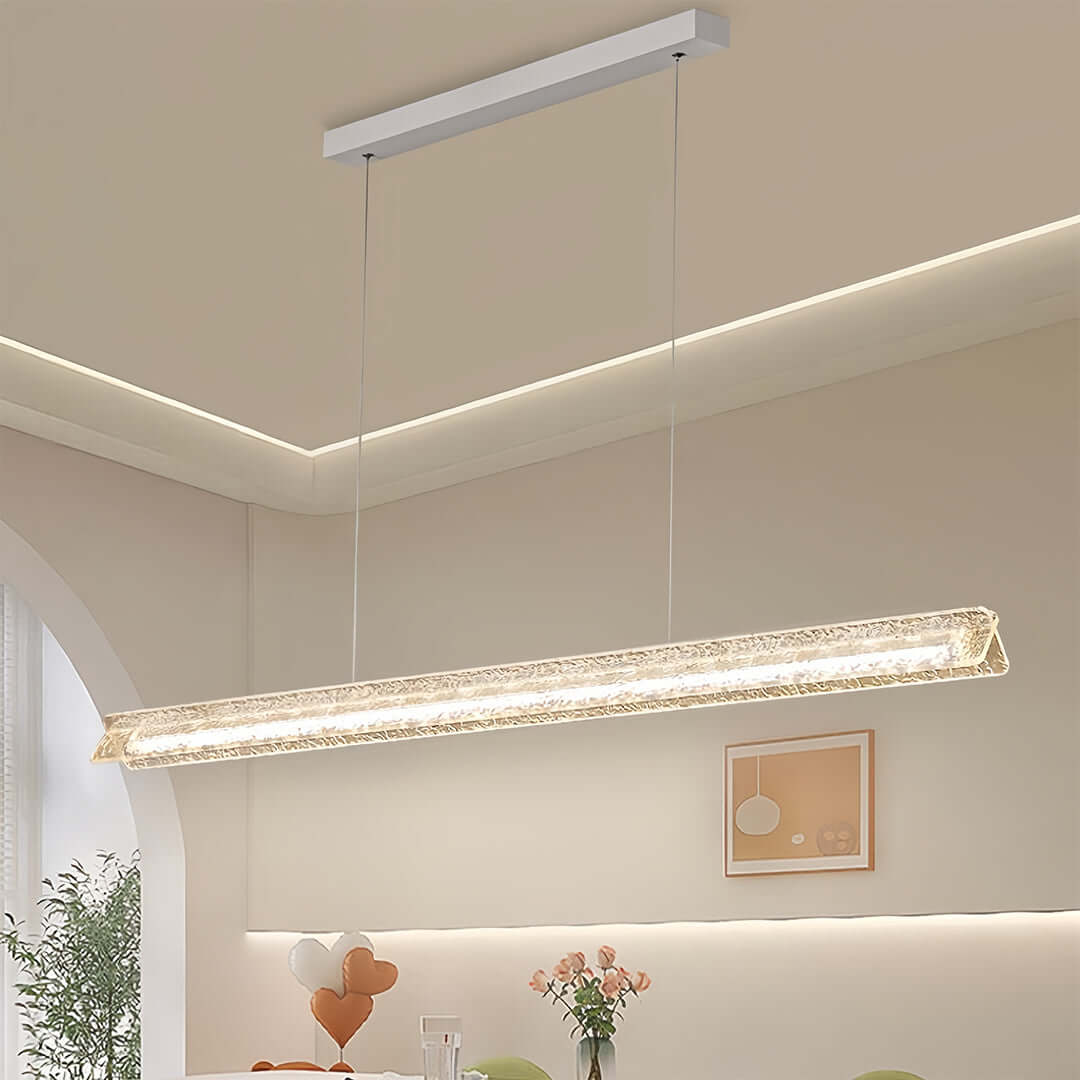 Elegant bubble glass modern white pendant light installed above a countertop in a bright, arched interior space.