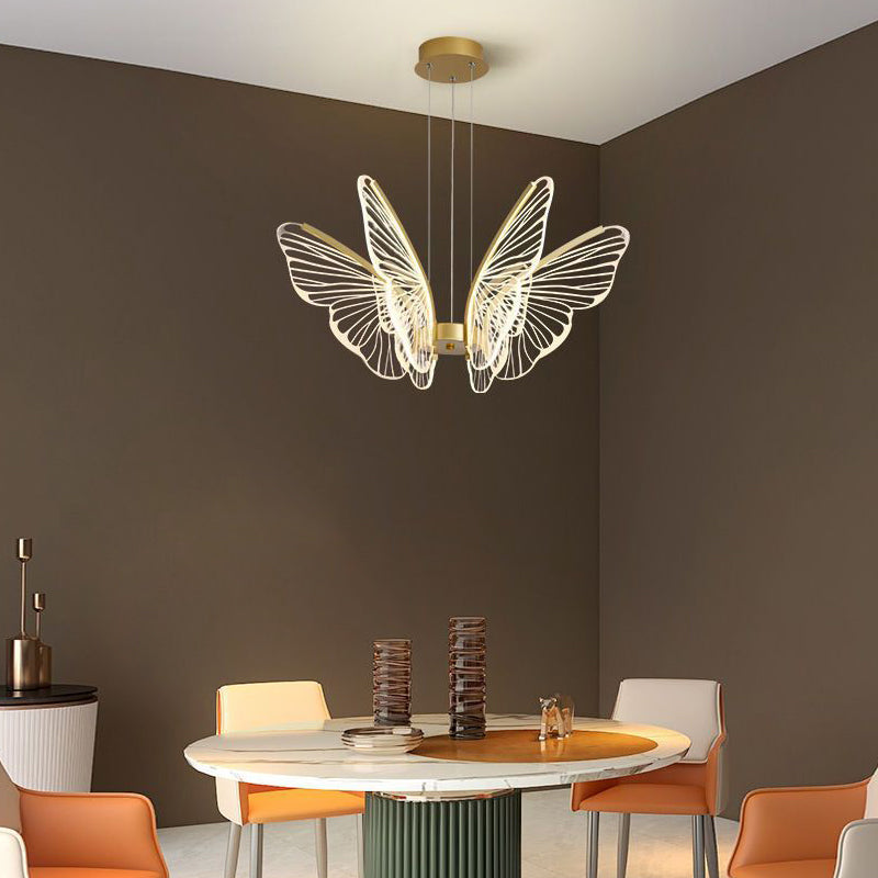 Butterfly pendant light illuminating a modern dining area with warm, artistic glow.