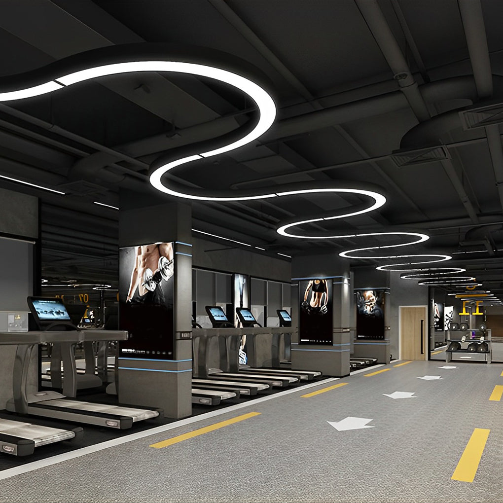 C shape LED pendant lighting system in industrial-style showroom ceiling.
