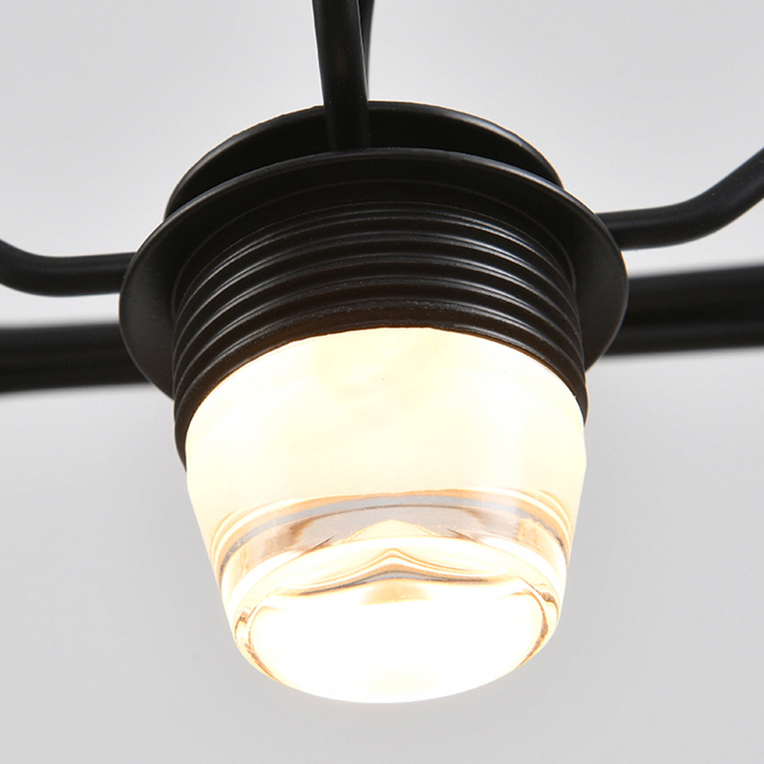 Detailed view of caged pendant light socket and bulb, emphasizing industrial style materials and soft lighting effect.