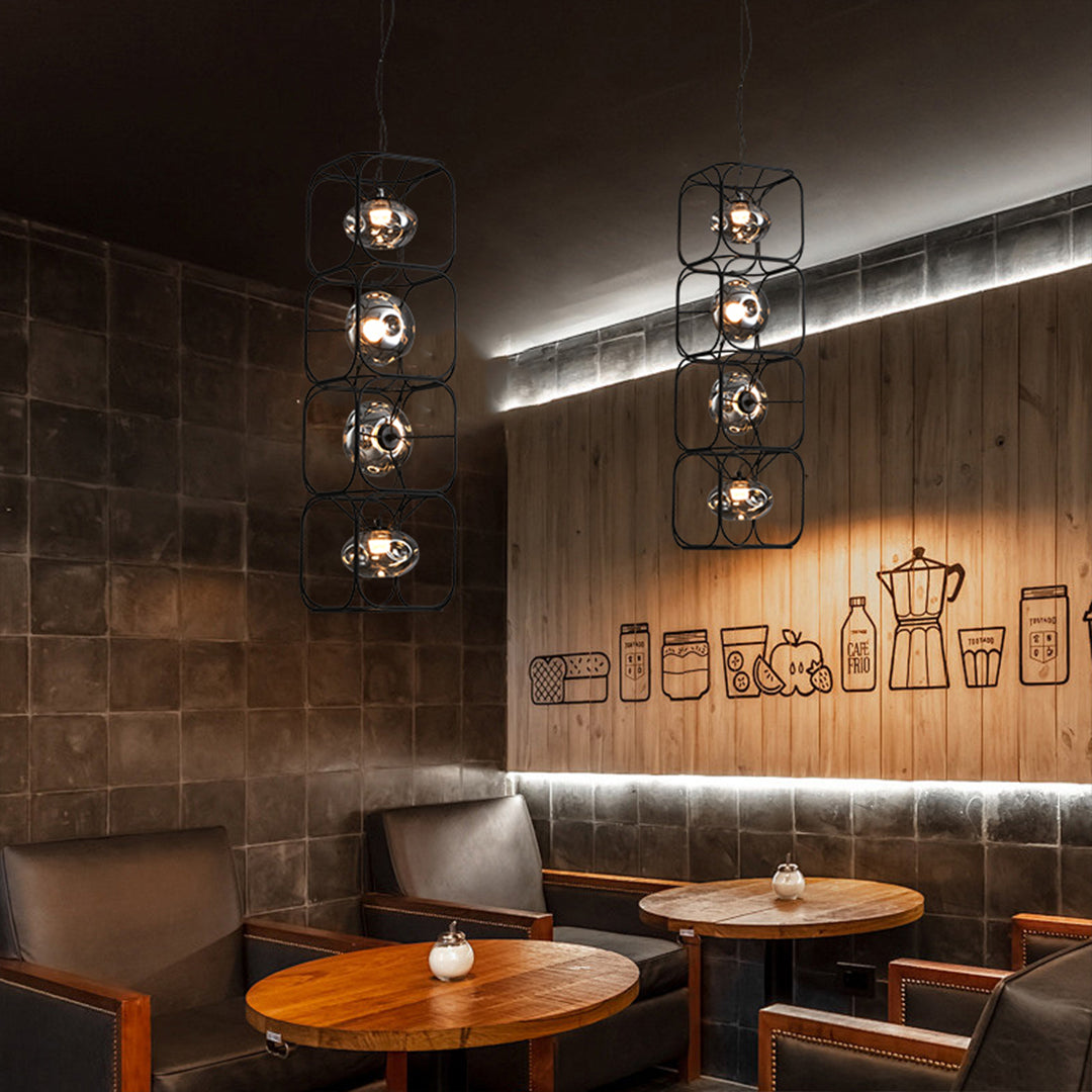 Caged pendant light installed in a cozy café interior, blending industrial metal structure with warm atmospheric lighting.