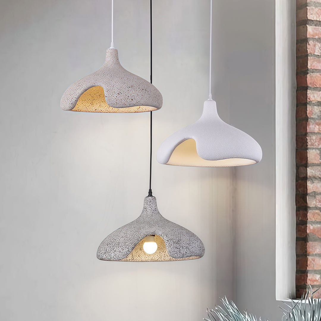 Set of cement pendant light in gray and white, mounted on concrete wall for modern industrial style.