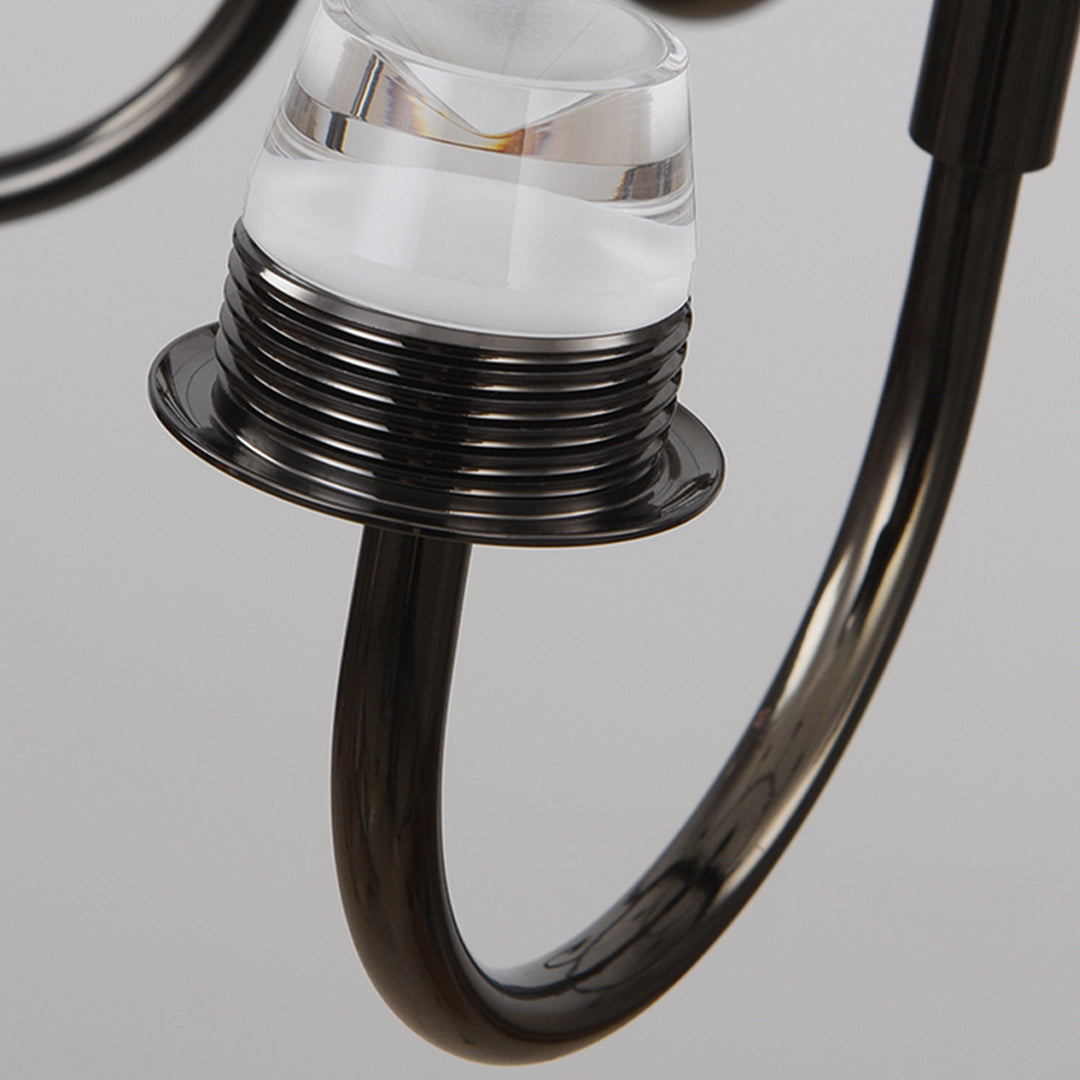 Close-up detail of chandelier arm connection showing decorative metalwork and glass shade mounting