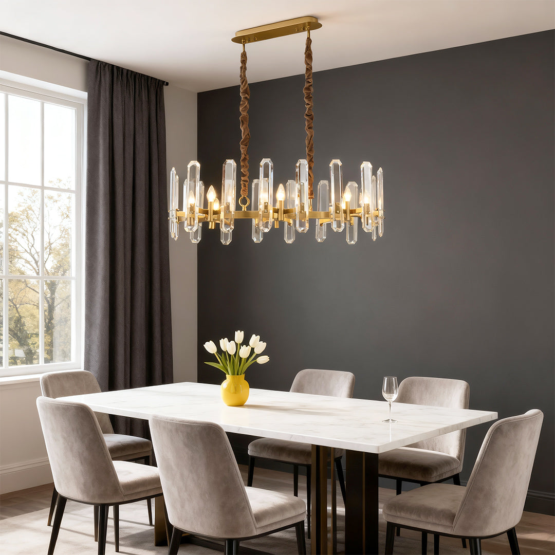 Modern luxury chandeliers above modern dining table with marble top and designer chairs