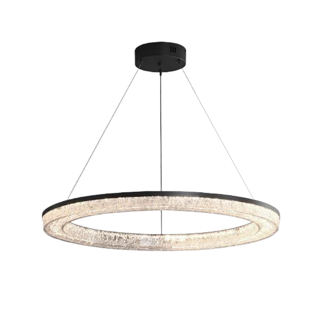 Circle pendant light with a metallic frame, casting a warm glow in a contemporary interior setting.