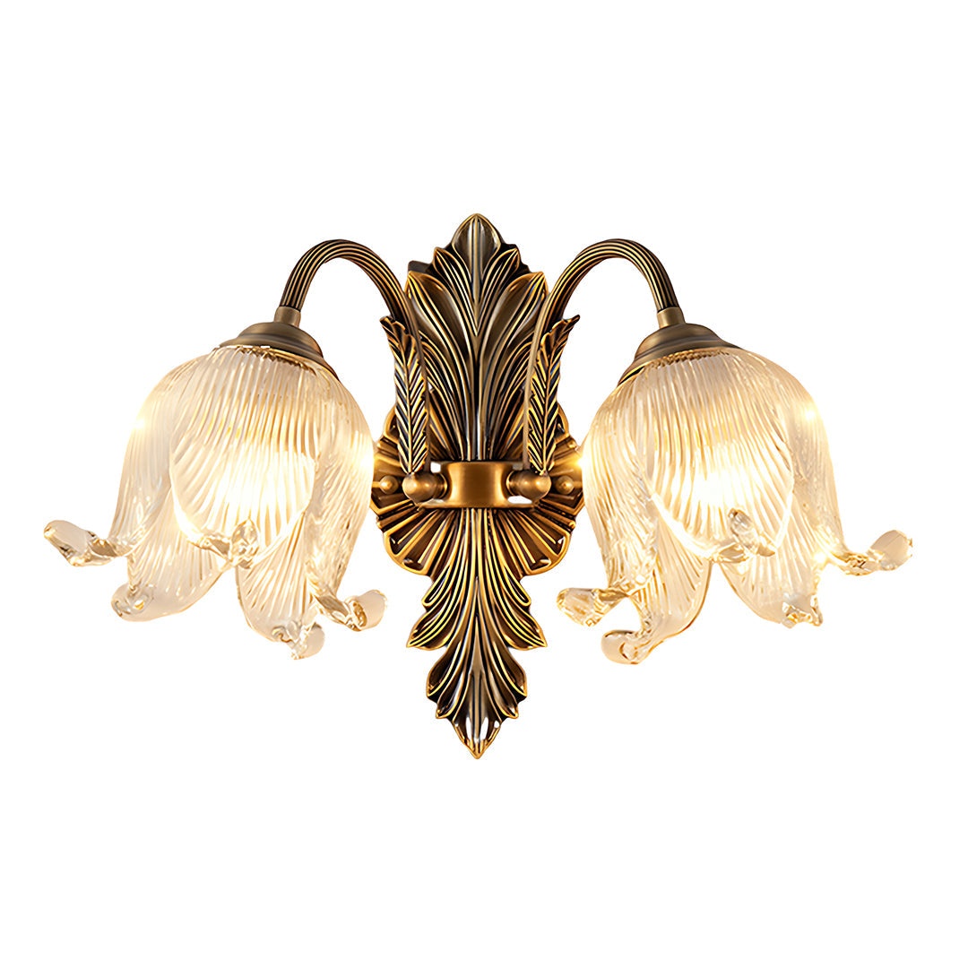 Classic brass wall lights with dual arms and fluted glass shades on elaborate backplate