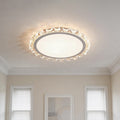 Beautiful white round led ceiling light with crystal edges illuminating a classic home hallway.