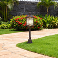 Classic LED post light fixture with decorative lantern design installed in tropical landscaped driveway