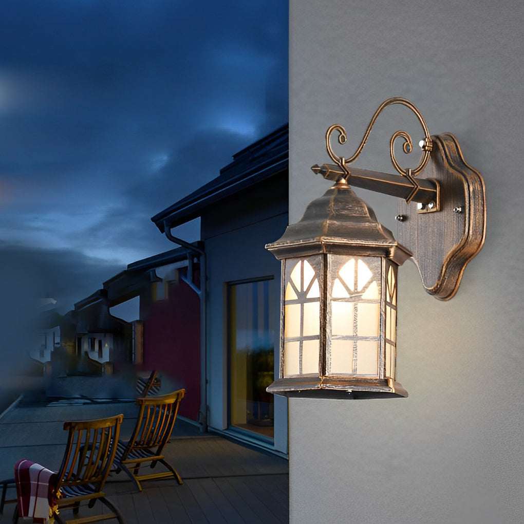 Classic porch light in bronze with decorative scroll arm and frosted glass, ideal for traditional home exteriors.