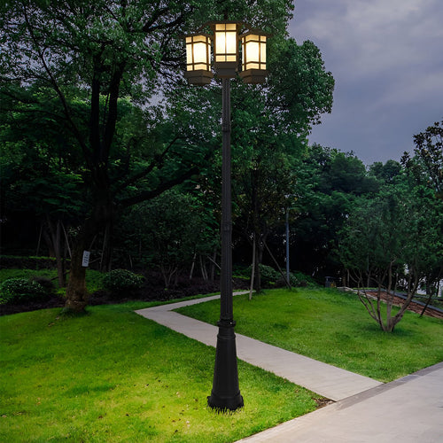 2 head outdoor post light with classic design in green park setting.