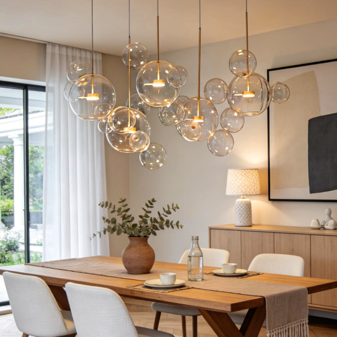 Clear bubble chandelier hanging over wooden dining table in contemporary interior.