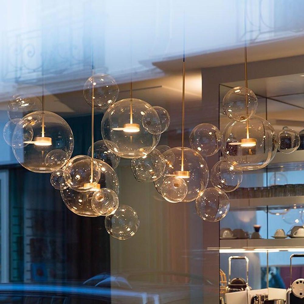 Clear bubble chandelier installed in restaurant or cafe setting.