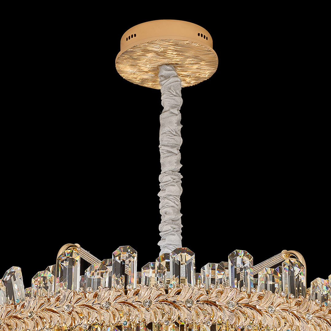 Close-up view of chandelier lamps crystal reflecting golden light.