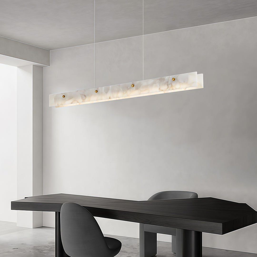 Close-up of a copper metal pendant light, showcasing its unique marble and gold design.