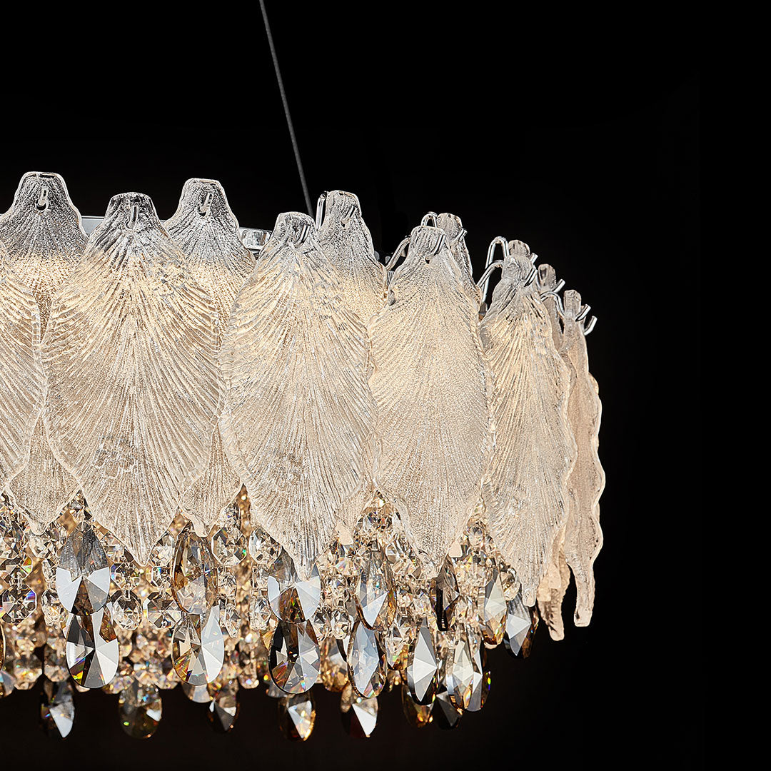 Close-up of country French chandelier showing leaf-shaped crystals and gold accents.