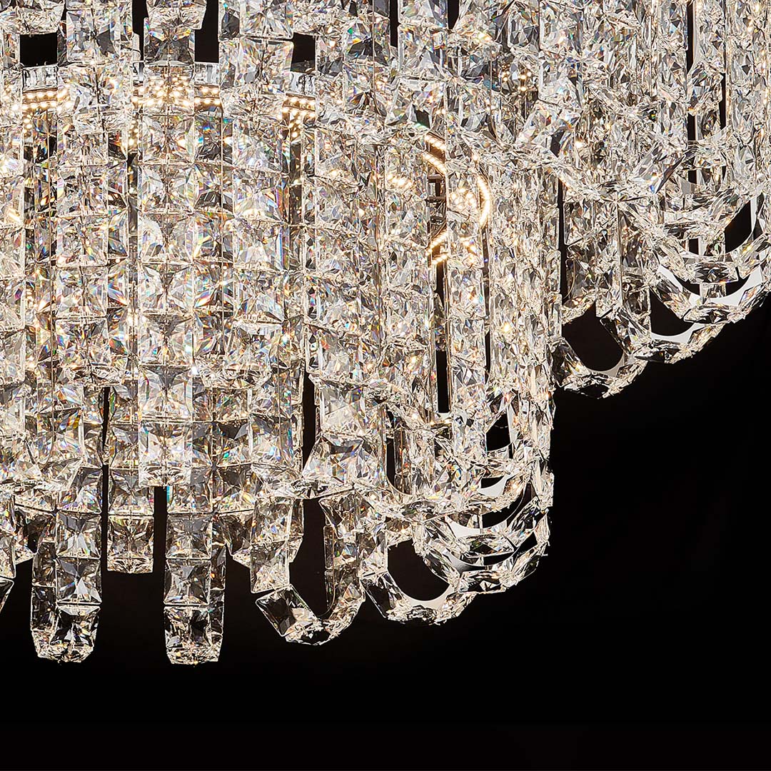 Close-up of faceted glass and metal details on luxury crystal chandelier modern.
