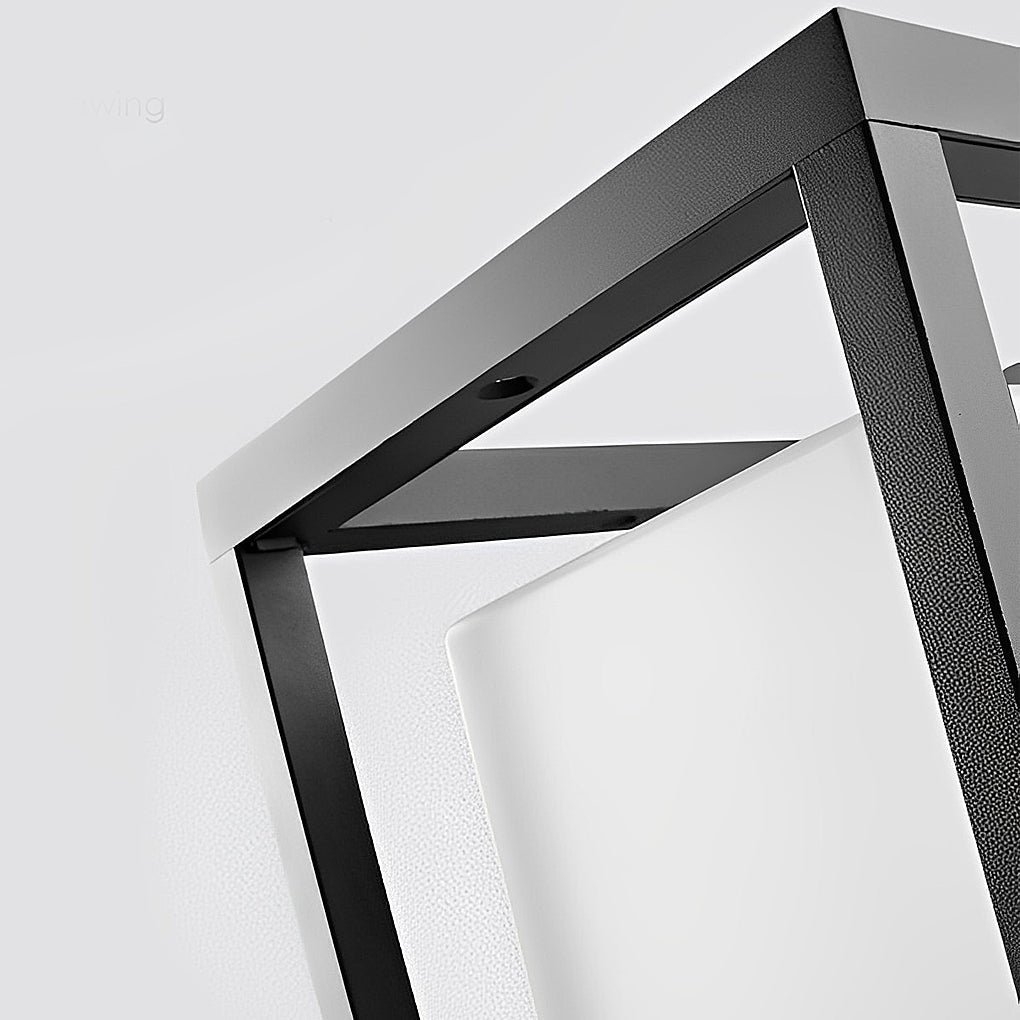 Close up of garden pedestal lights showing sleek black frame and frosted glass.