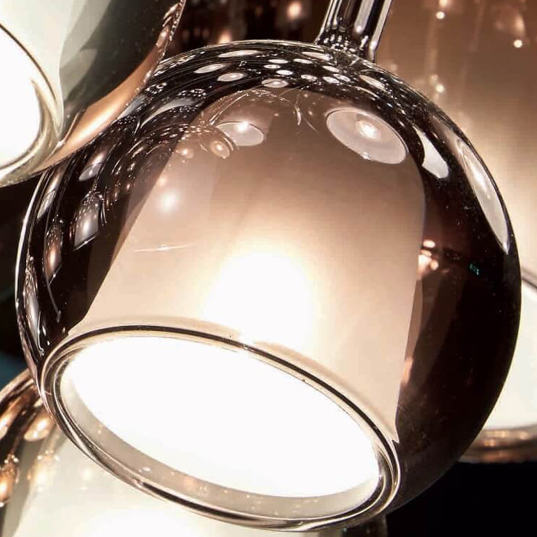 Close up view of a glass ball pendant light, highlighting its transparent and reflective glass surface.