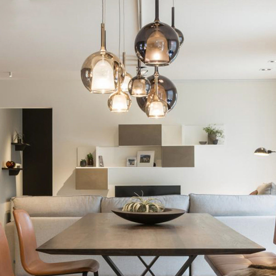 Close up of glass ball pendant lights hanging in a cluster, showcasing their unique and modern design.