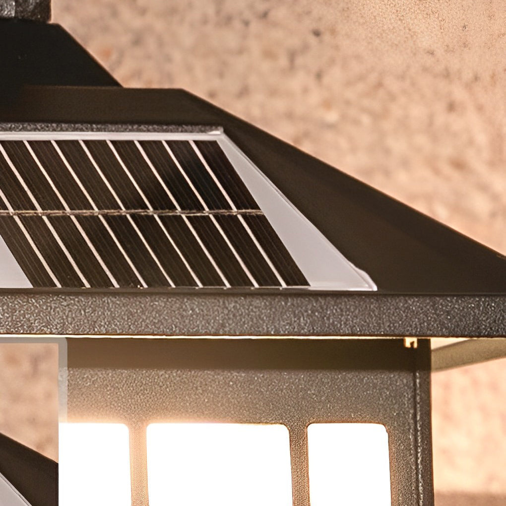 Close-up of lantern wall sconce frosted glass panels with black frame and warm light.
