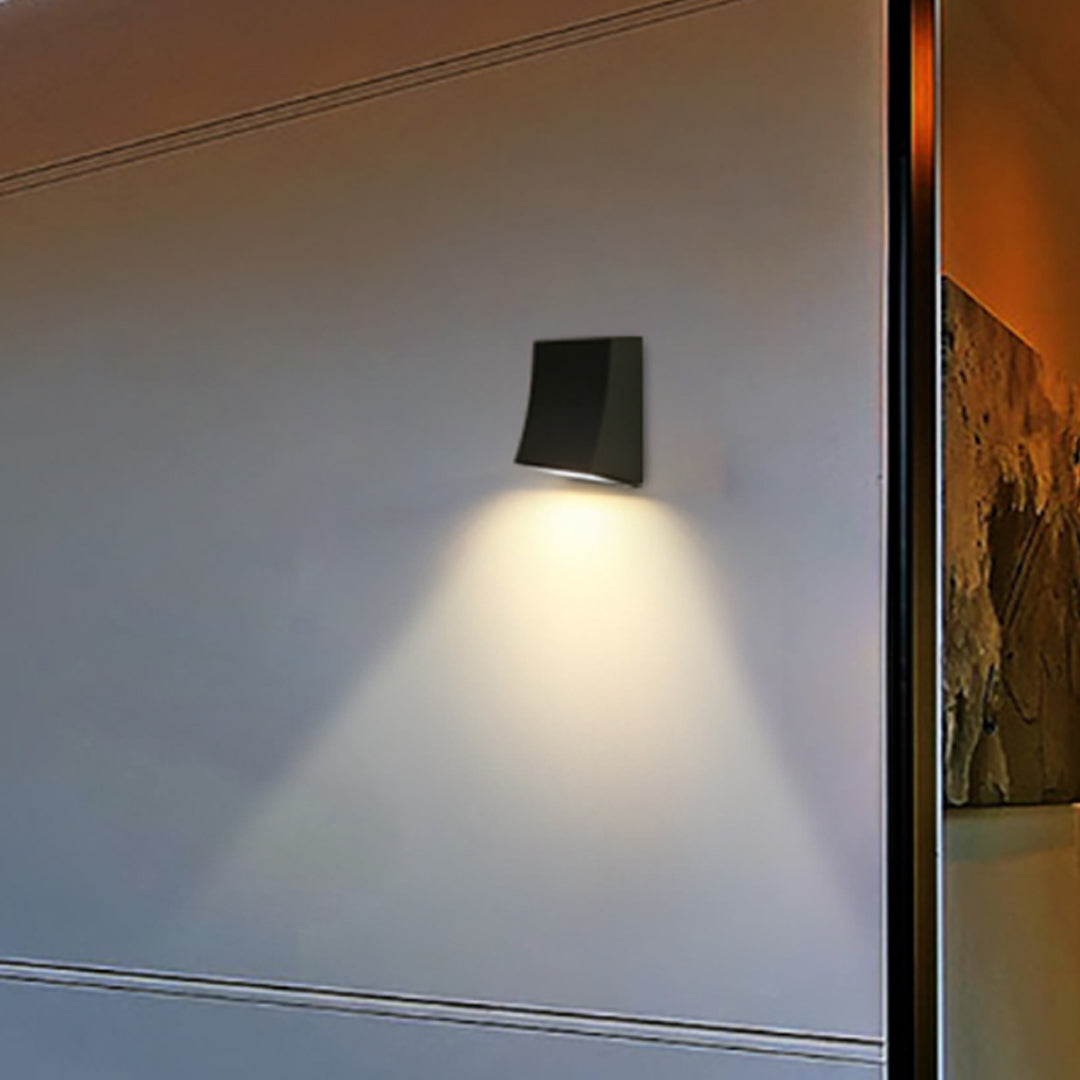 Close-up of LED outdoor wall sconce, showcasing its minimalist design and warm light.
