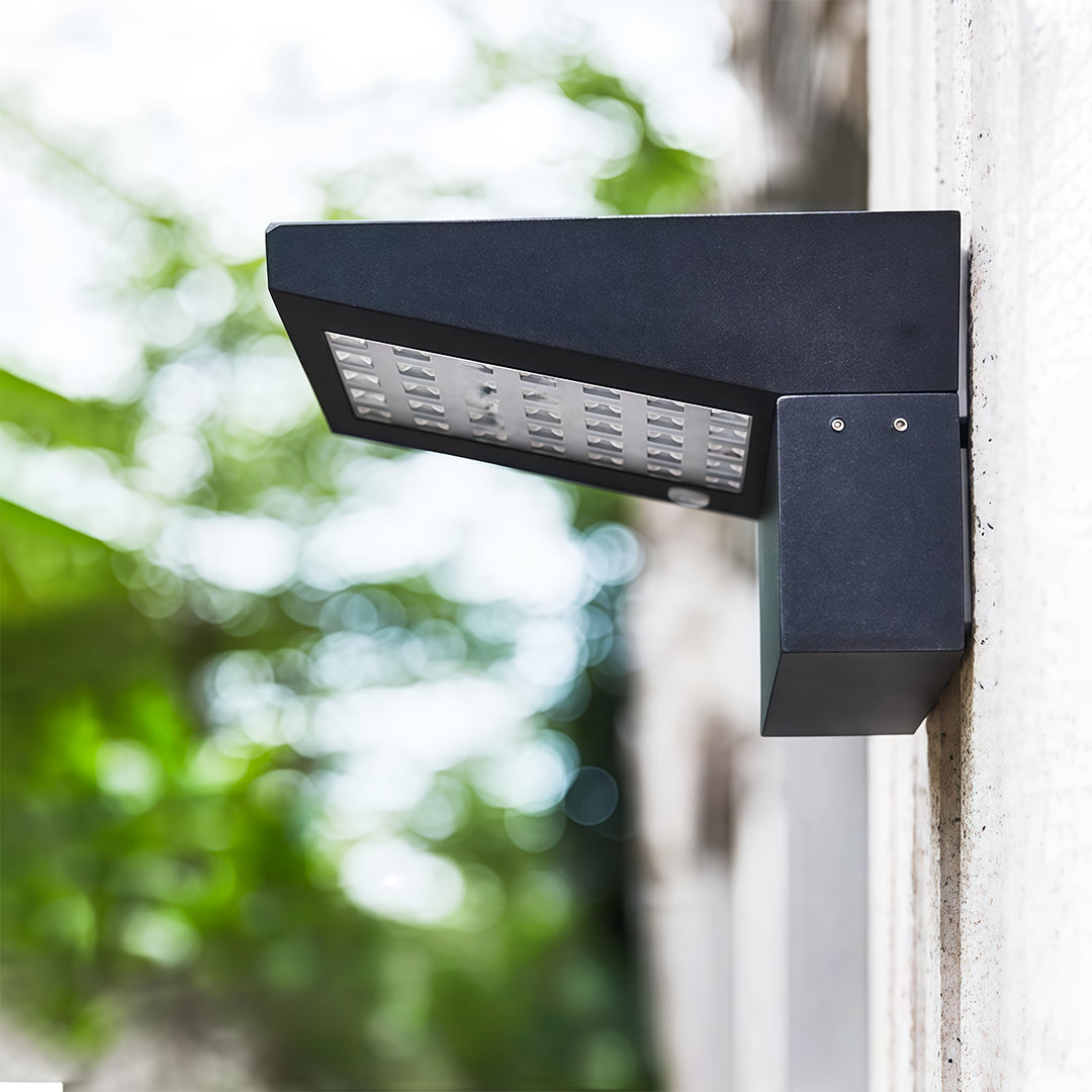 Close-up view of a modern LED panel wall mount outdoor light fixtures in a black finish.