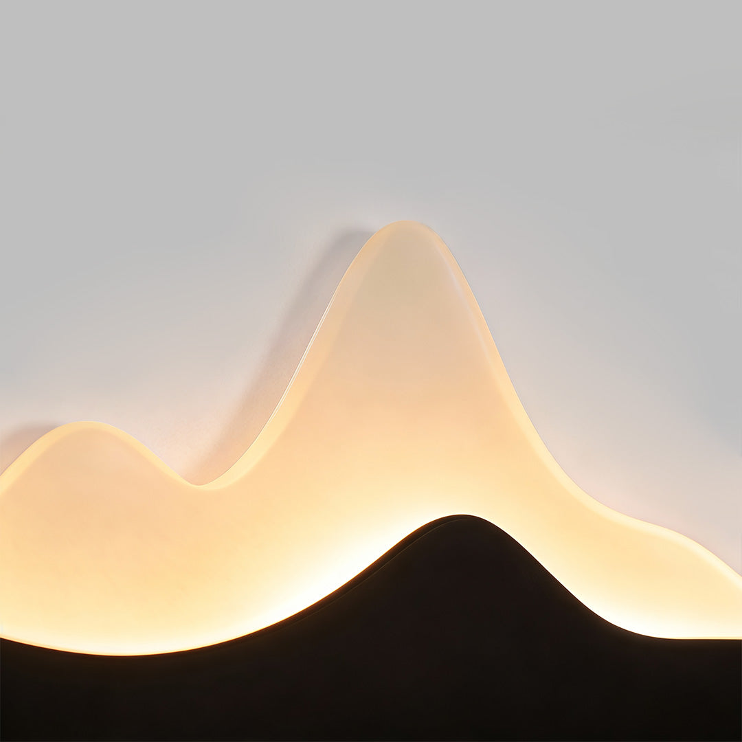 Close-up of a mountain LED wall light, showcasing its unique silhouette and warm light.