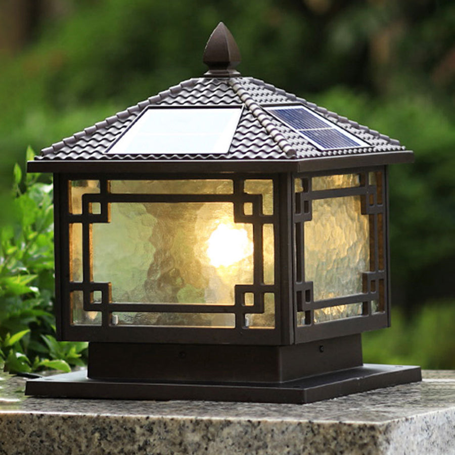 Close up of outdoor garden pillar lights, highlighting intricate design and warm light effect.