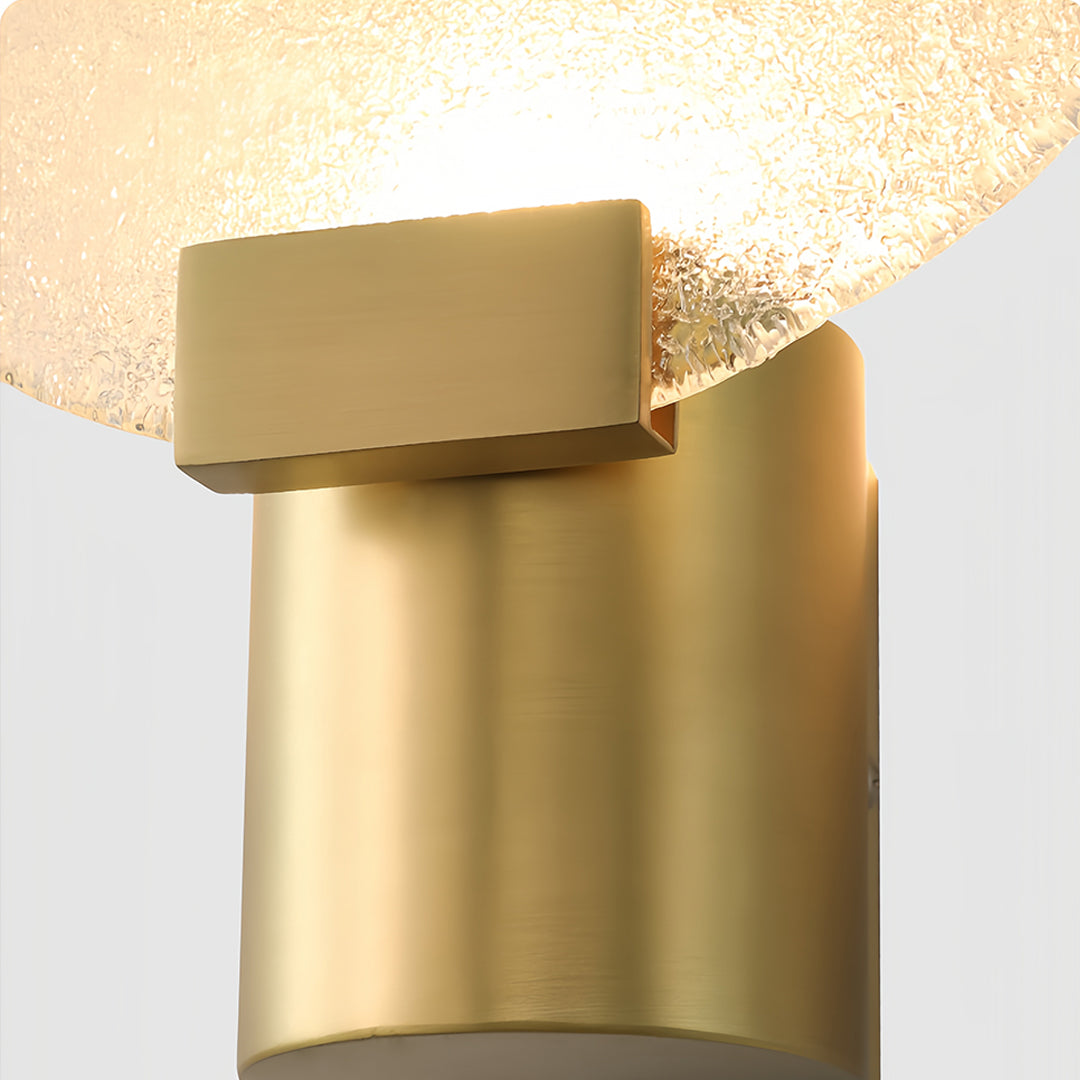 Close-up of a round wall light with a frosted glass shade, focusing on the intricate texture and light effect.