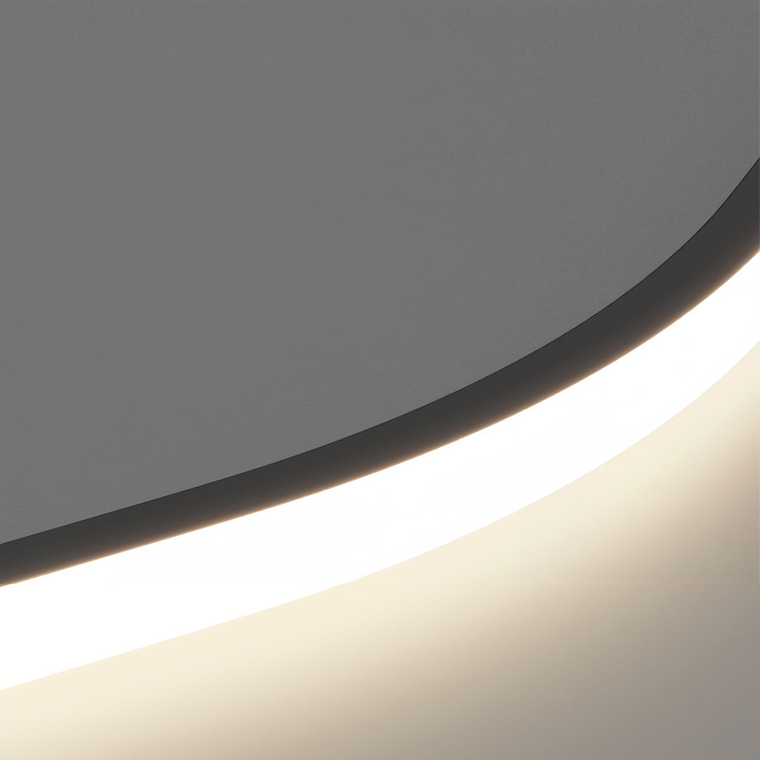 Close-up of the black kitchen island pendant light, emphasizing the soft, downward-facing glow and the smooth curve of the matte black body.