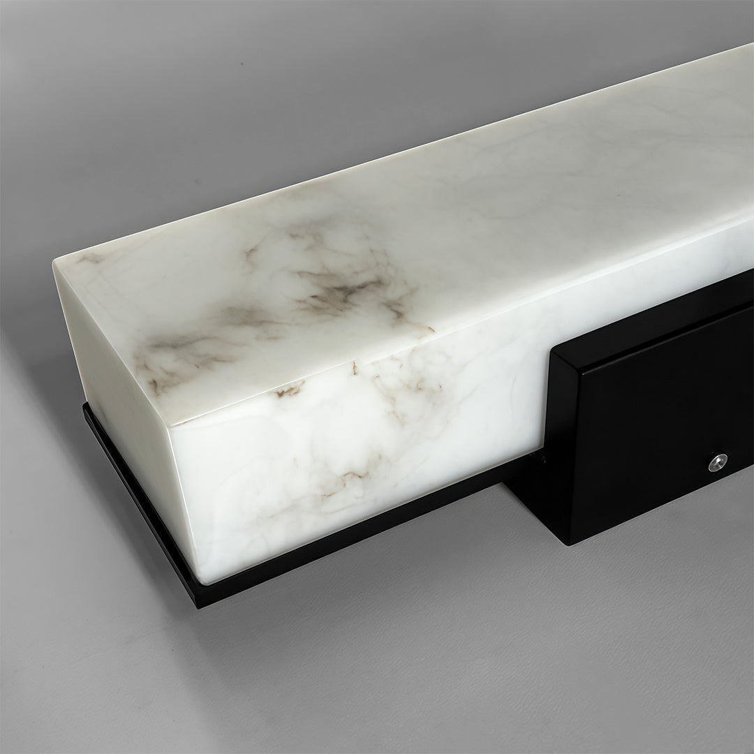 Close-up of square outdoor wall lights, showcasing the marble texture and warm light effect.