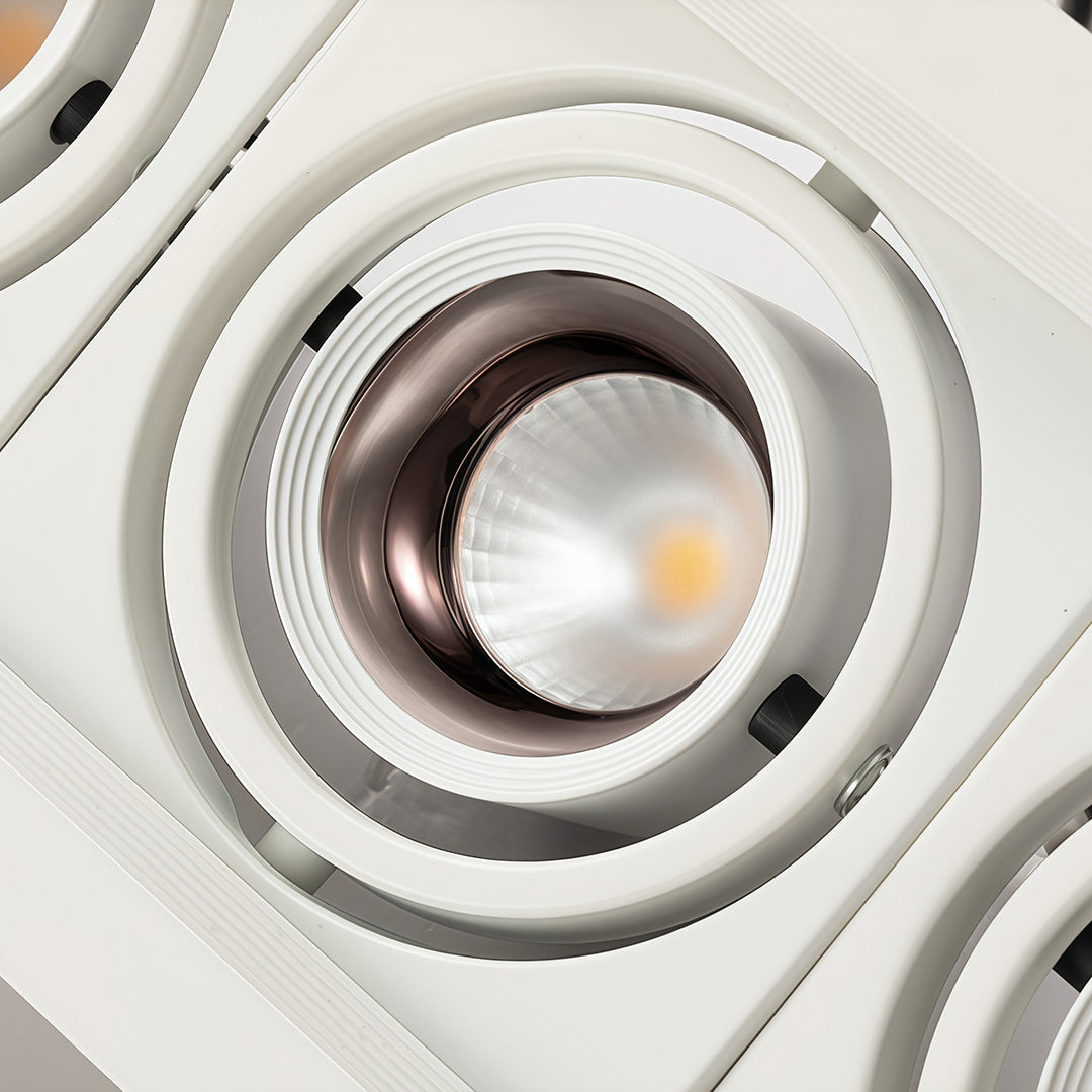 Close-up white LED indoor spotlight module with glass shade chandelier inspired concentric ring reflector design.